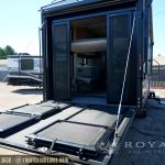 black enclosed car trailer with open door showing interior ramp and shelving at RV dealership