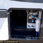 RV electrical leveling system control panel and water filtration system inside an open storage compartment