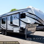 White and black Glacier Peak toy hauler with slide-out cargo area and extended awning