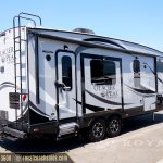 Glacier Peak travel trailer rear view showing extended awning and entrance door at dealership